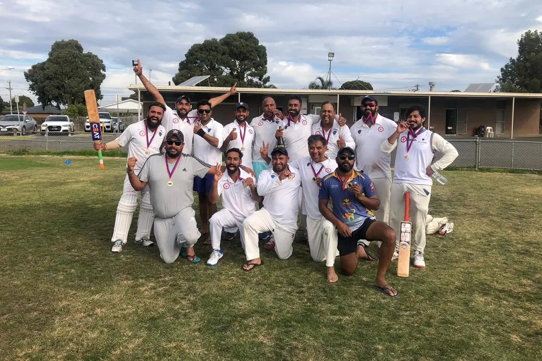 Chargers players celebrating with medals and bats raised